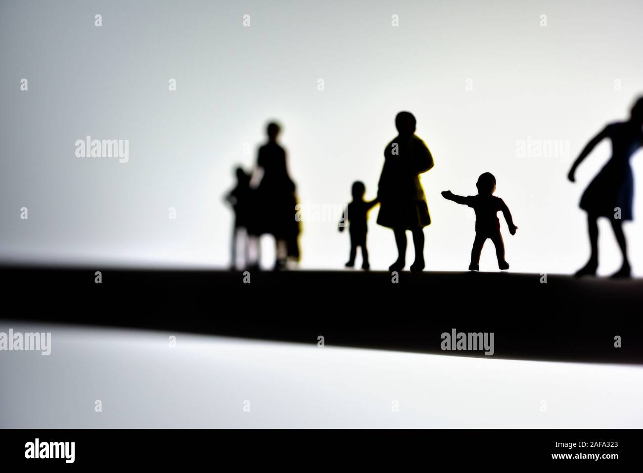 miniature figurines, mothers and children,concept,silhouette Stock Photo