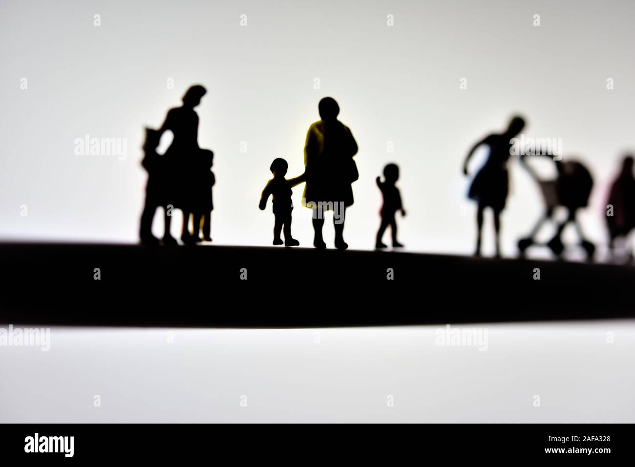 miniature figurines, mothers and children,concept,silhouette Stock Photo