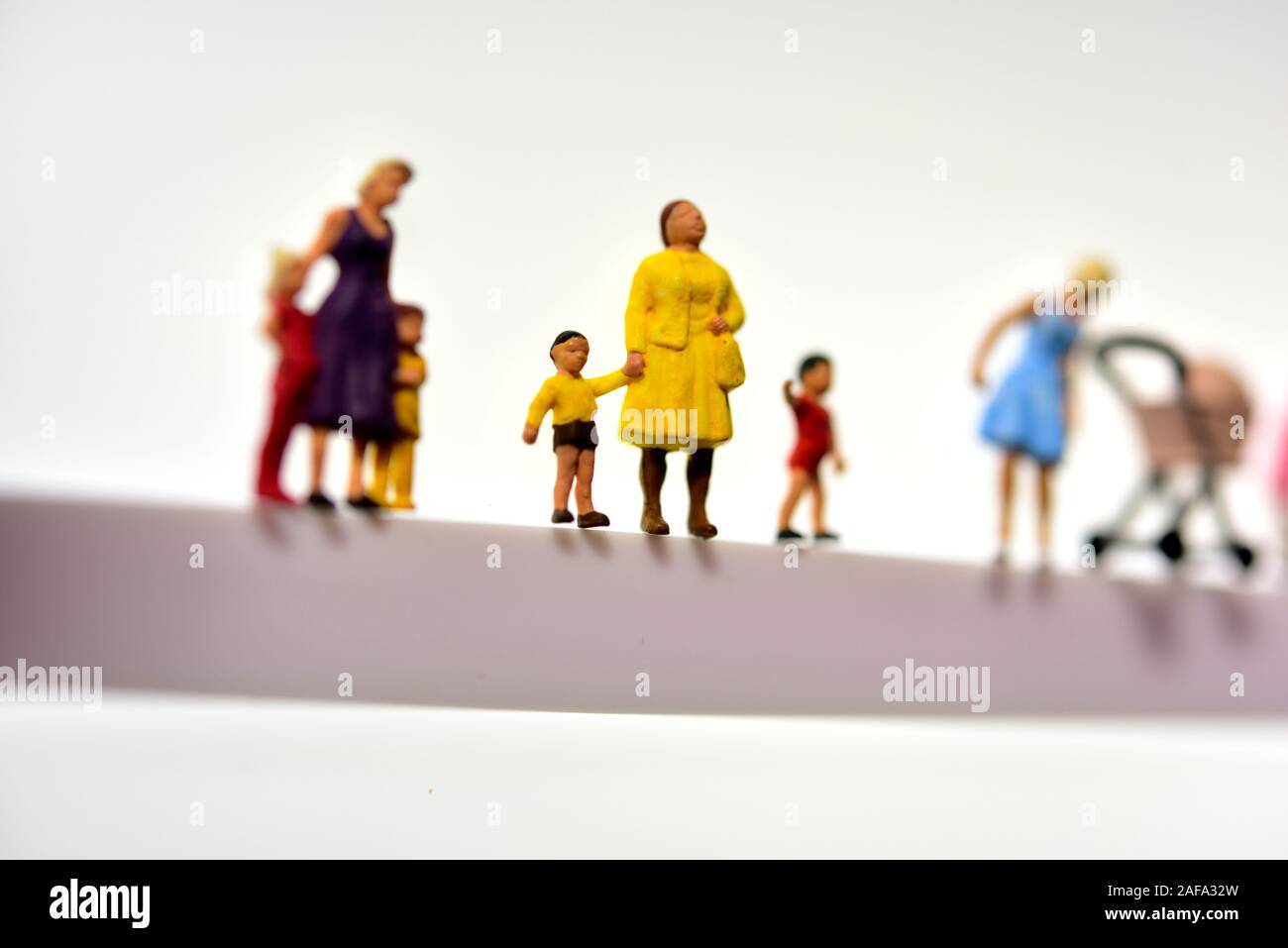 miniature figurines, mothers and children,concept white background Stock Photo