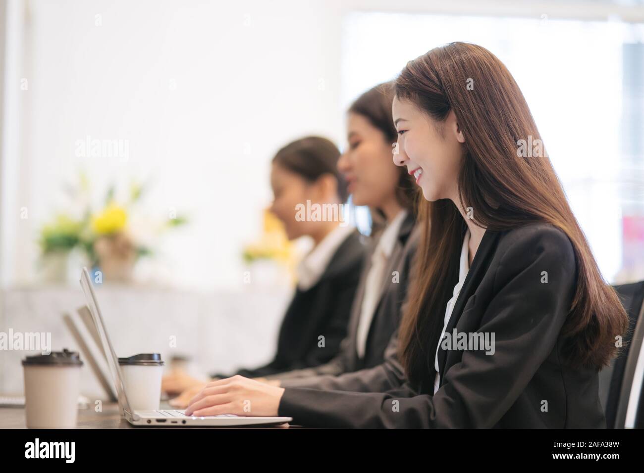 Asian businessmen are working with laptops in the office. Stock Photo
