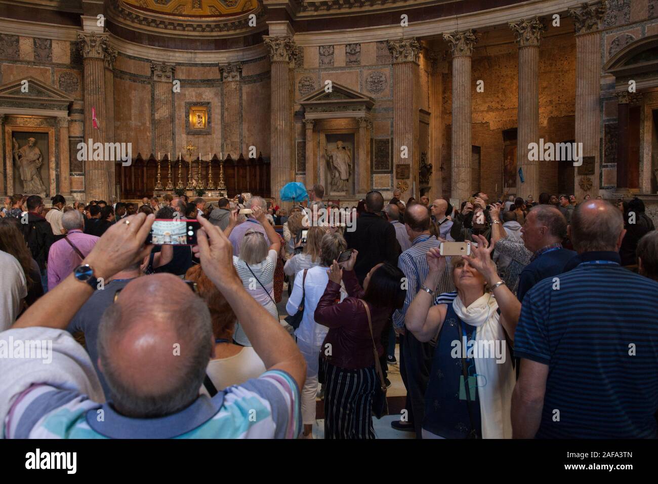 Visitors inside the Pantheon in Rome, a former Roman temple and now a church Stock Photo