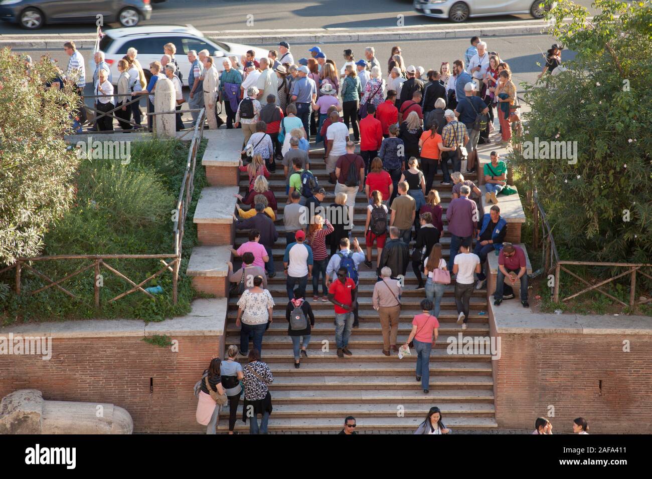 A tour group is led away from the Coliseum in Rome by a guide Stock Photo
