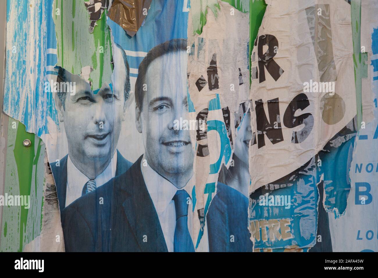 Torn political posters on a wall in Paris Stock Photo