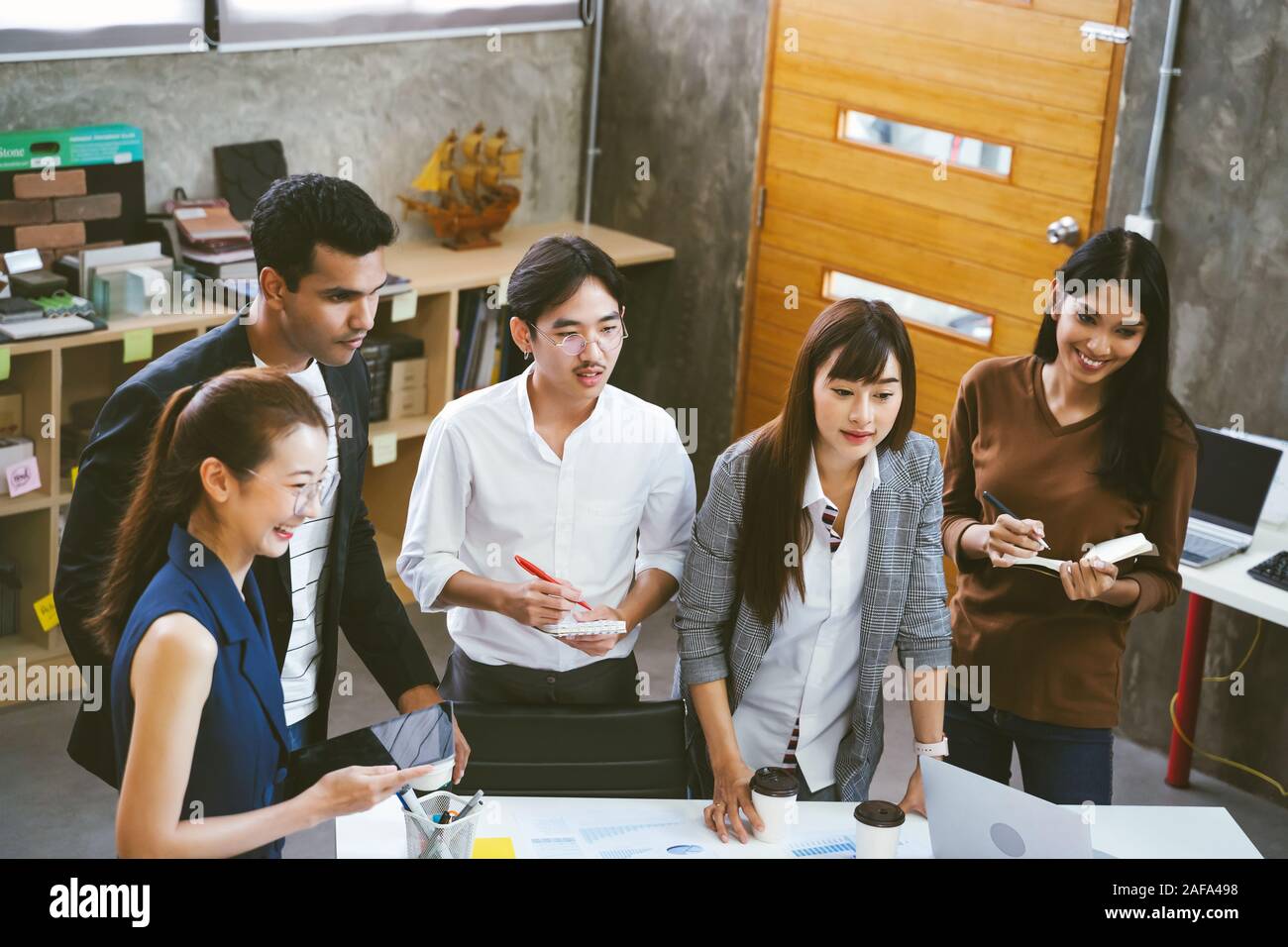 Group of Asian business people team meeting in modern office working ...