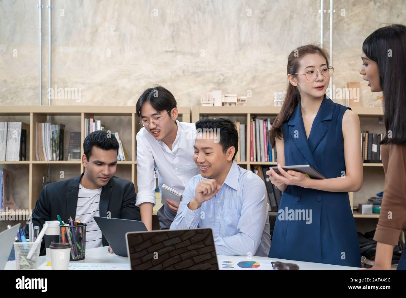 Group of Asian business people team meeting in modern office working ...