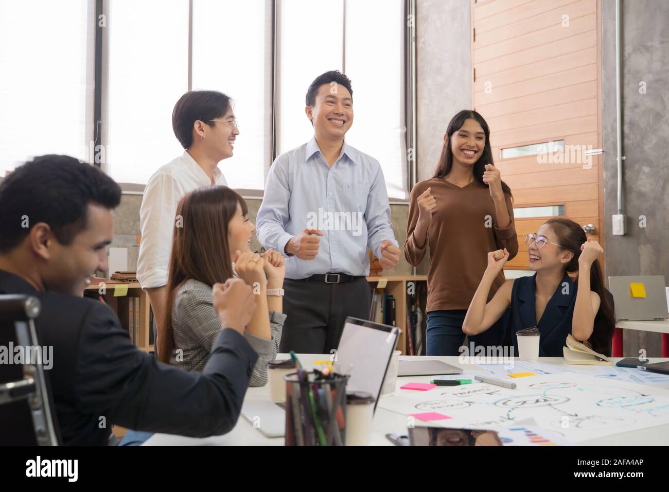 Group of Asian team creative business people Happy to be successful partnership teamwork concept Stock Photo