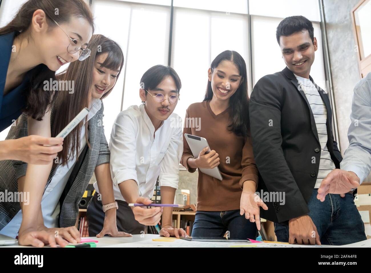 Group of Asian business people team meeting in modern office working ...