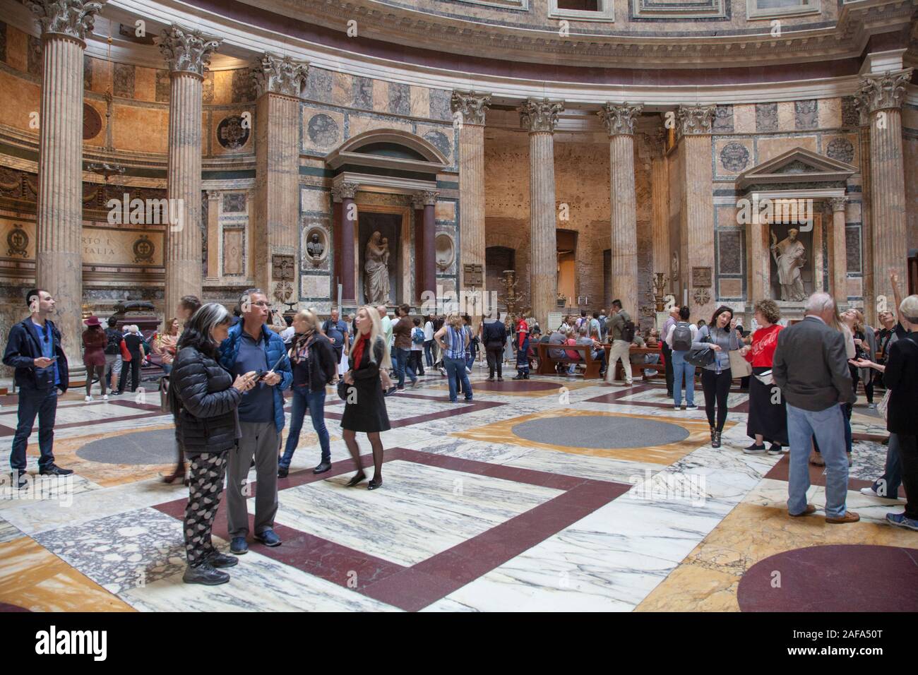 Visitors inside the Pantheon in Rome, a former Roman temple and now a church Stock Photo