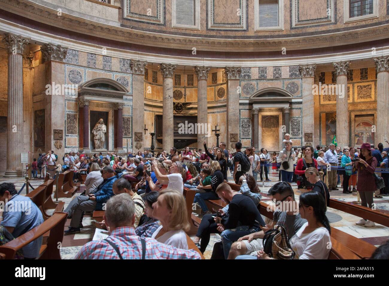 Visitors inside the Pantheon in Rome, a former Roman temple and now a church Stock Photo