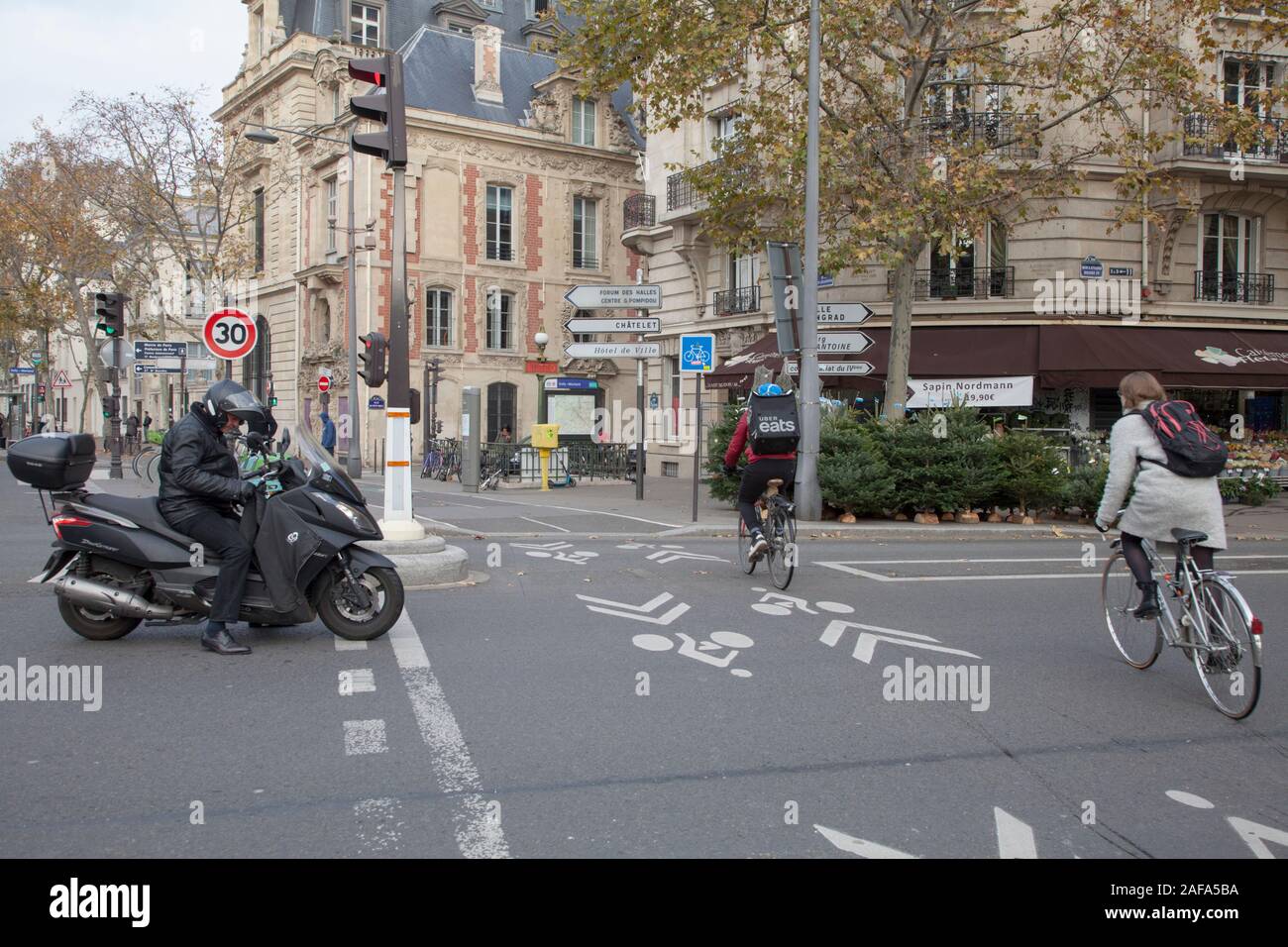 Cyclists on a marked cycle only lane in Paris City centre Stock Photo