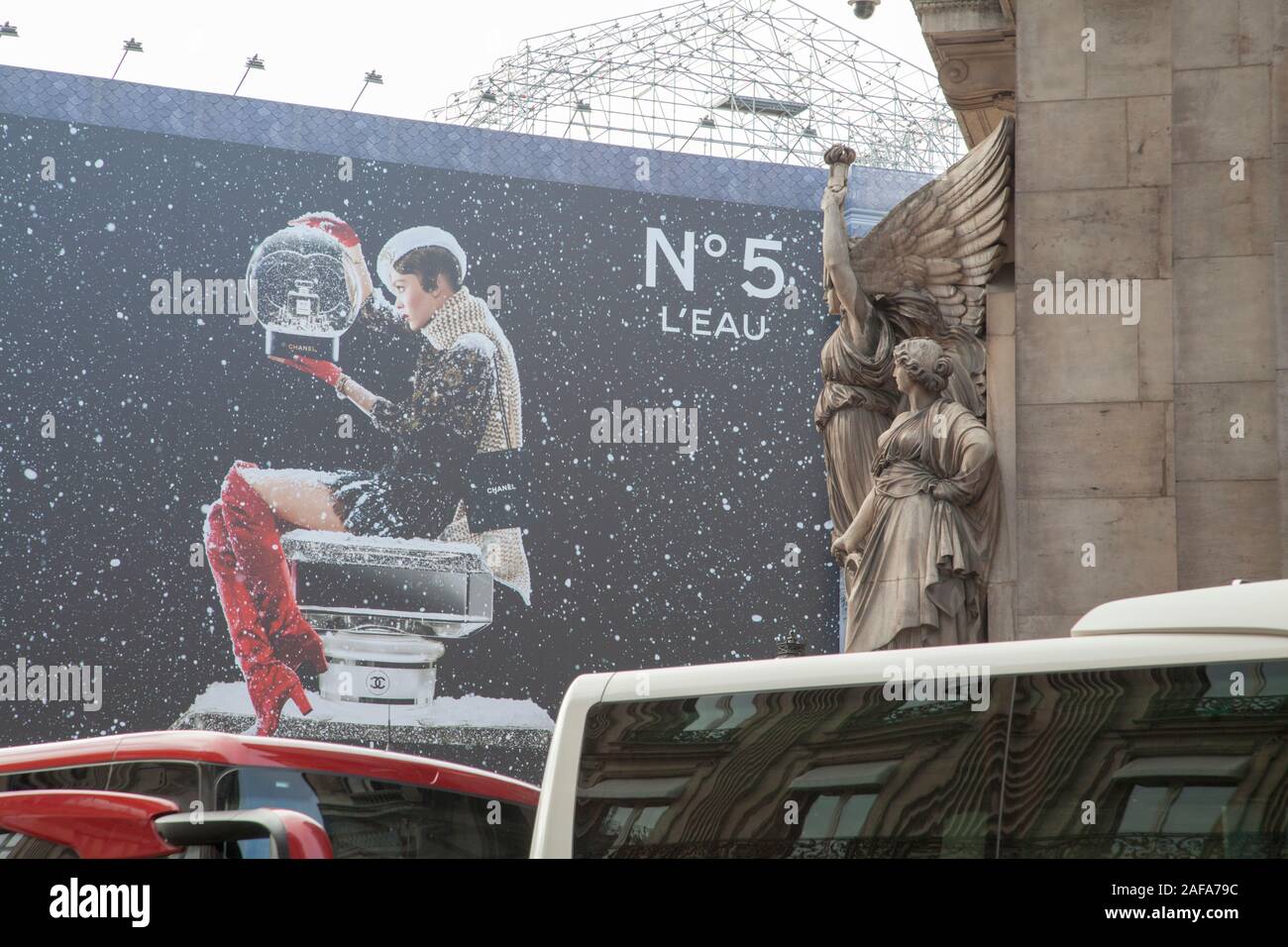 Statues on the Paris Opera building and a huge advert for Chanel No.5 perfume. Christmas 2019 Stock Photo