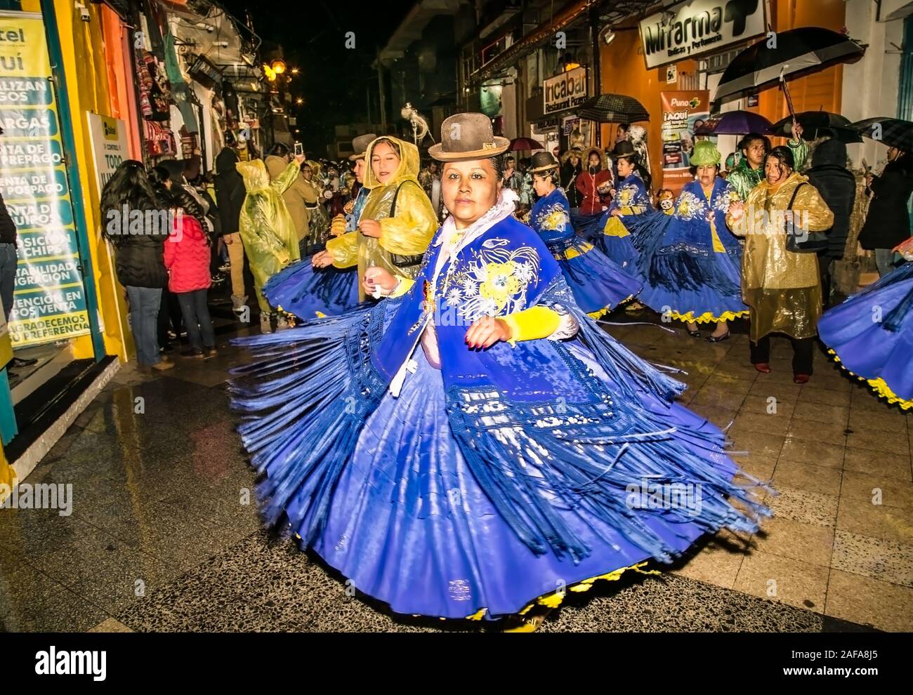 Puno, Peru - Jan 5, 2019: Authentic Colorful Carnival on the streets of Puno by night, Peru near the high altutude Titicaca lake . South America. Stock Photo