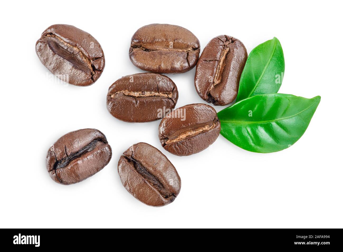 Heap of roasted coffee beans with leaves isolated on white background ...