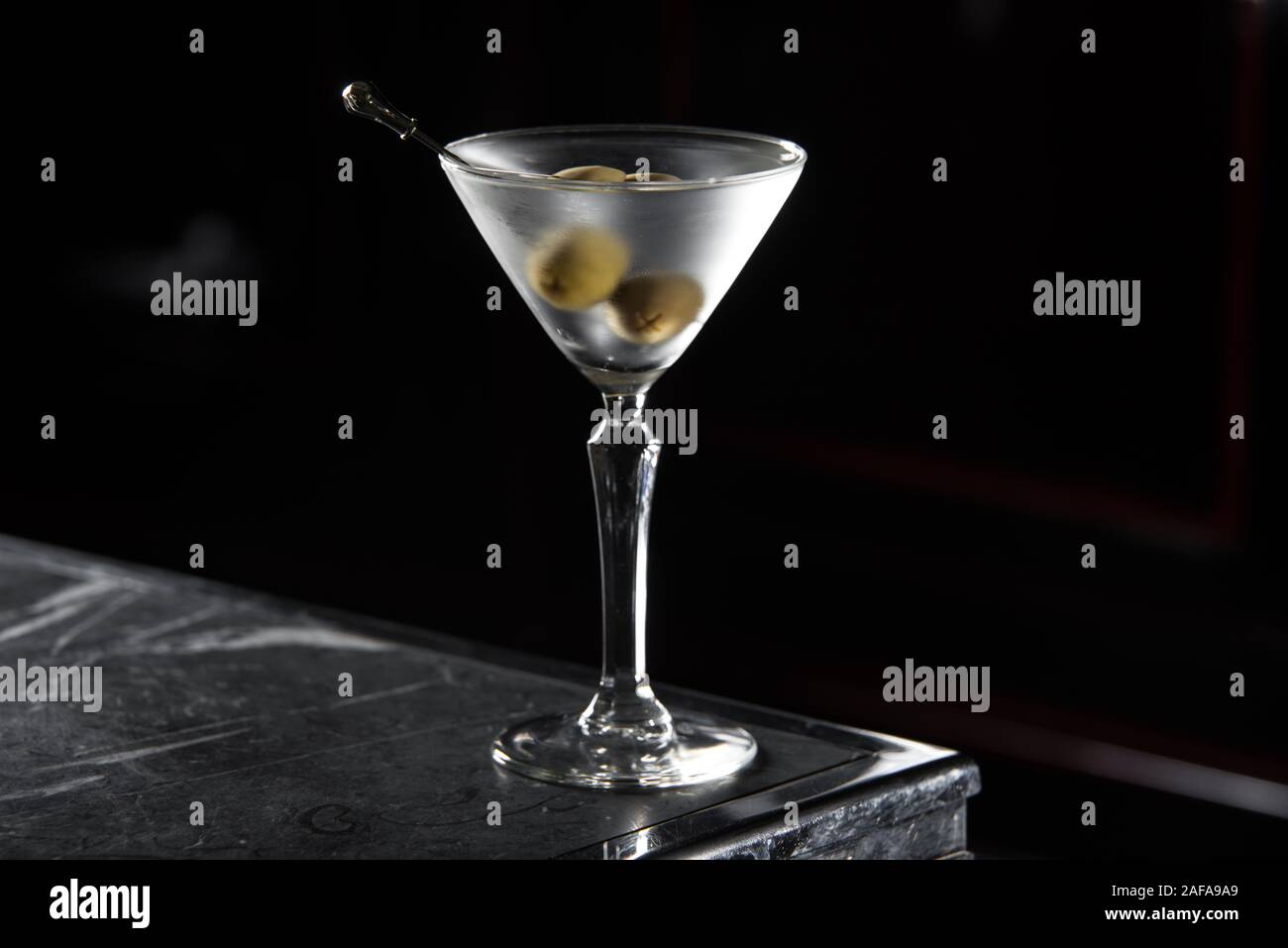 Dry Martini cocktail on a bar desk. black background. Stock Photo
