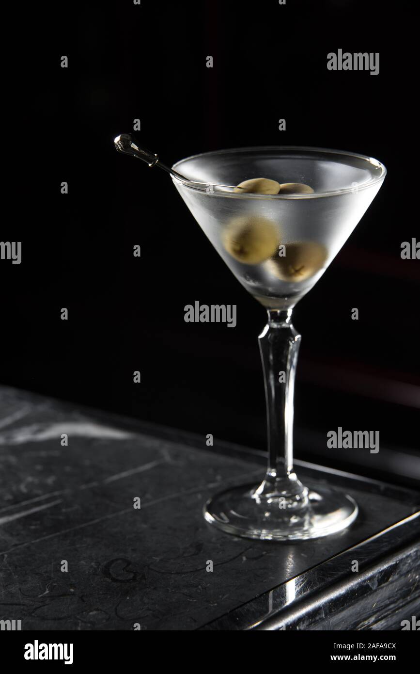 Dry Martini cocktail on a bar desk. black background. Stock Photo