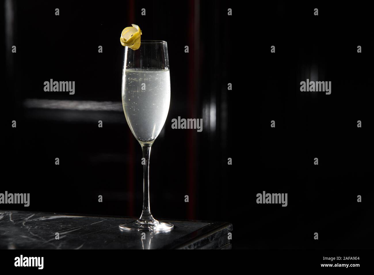 french cocktail on a bar desk. black background. Stock Photo