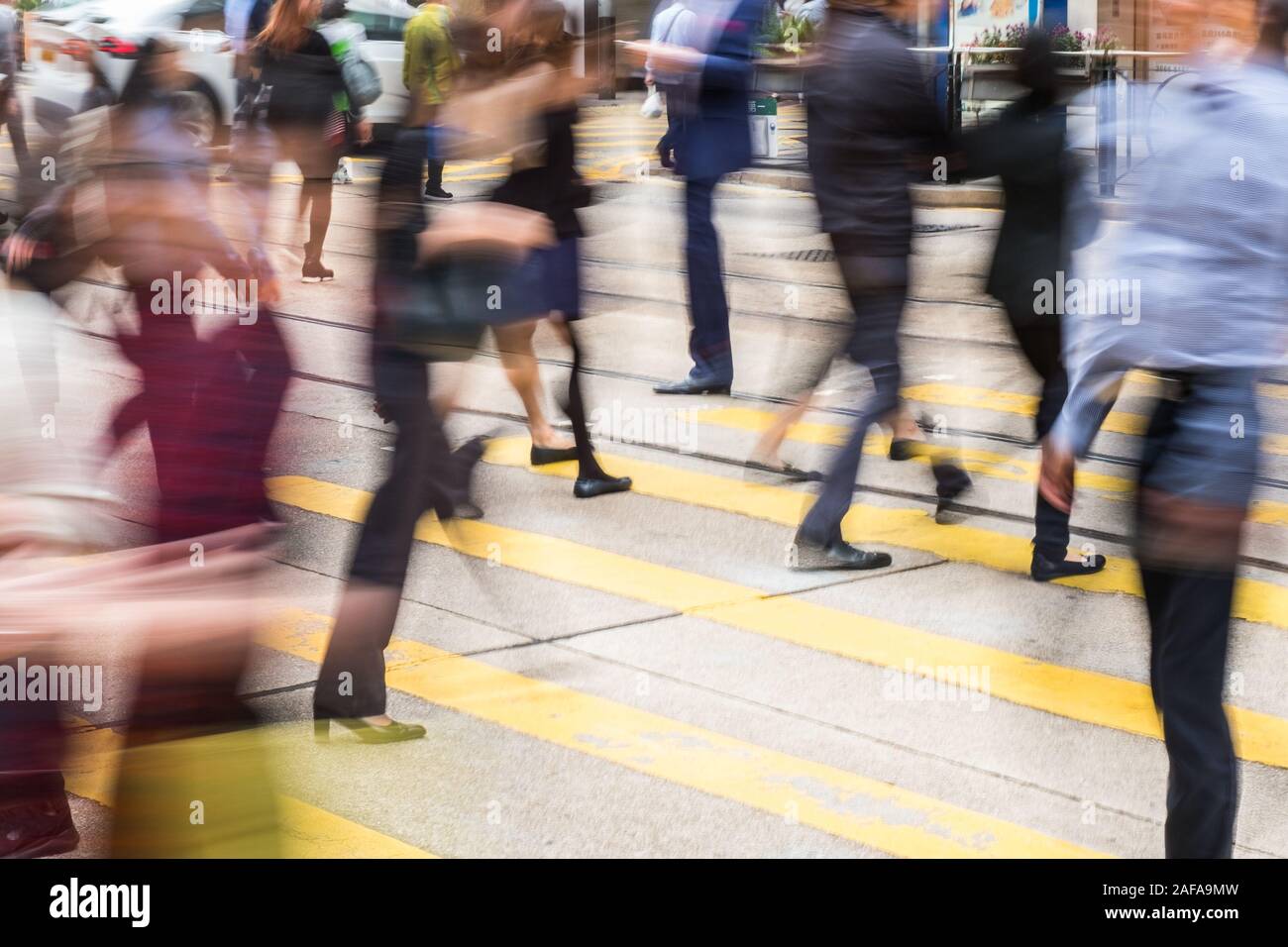 people crossing street on pedestrian crossing,  motion blur Stock Photo