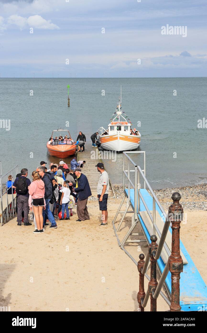 Holidaymakers queueing for places on boat trips around bay, Llandudno Stock Photo