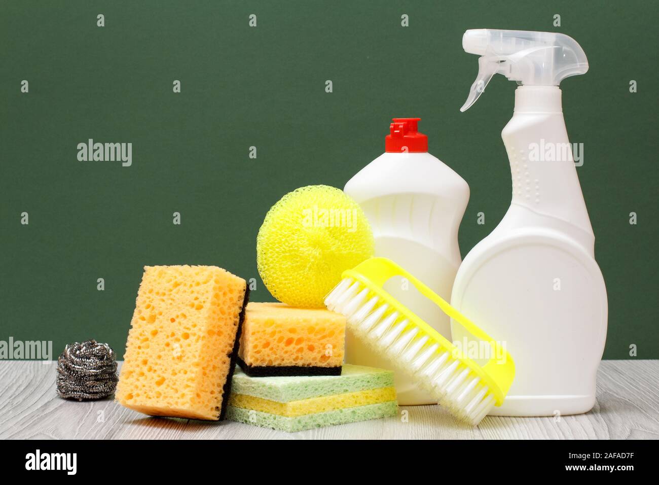 Plastic bottles of dishwashing liquid, glass and tile cleaner, yellow