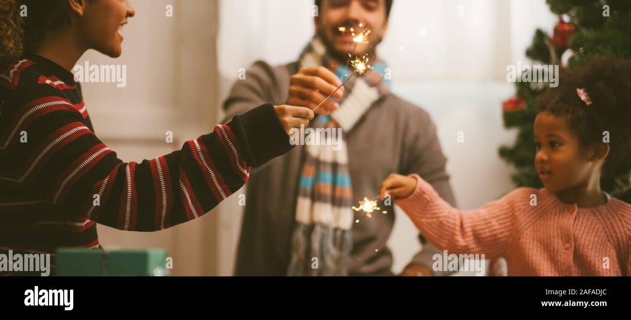 family celebrating with sparkler fireworks .Christmas Celebration tradition concept. Stock Photo