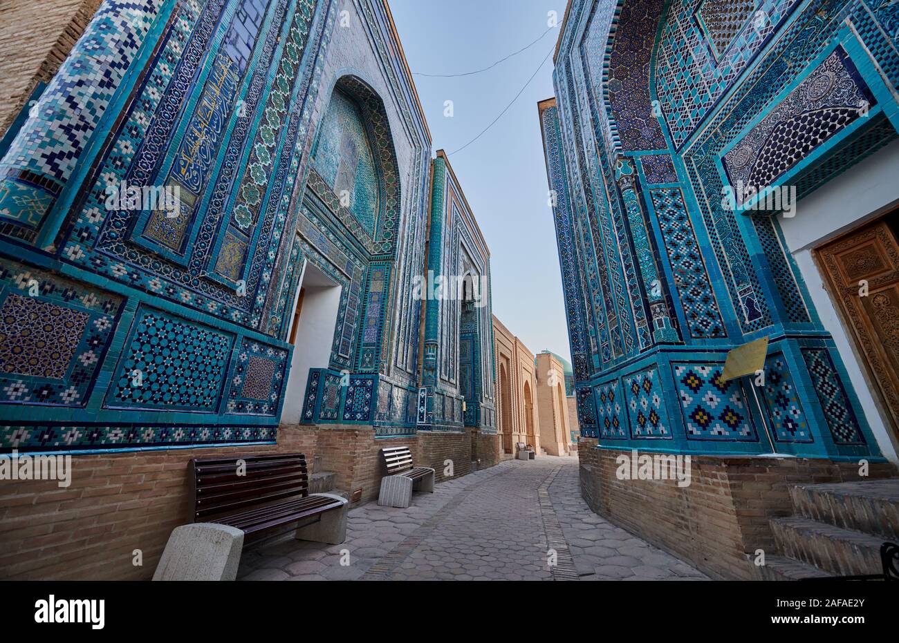 narrow path through facades heavily decorated with blue tiles in necropolis Shah-i-Zinda, Samarqand, Uzbekistan, Central Asia Stock Photo