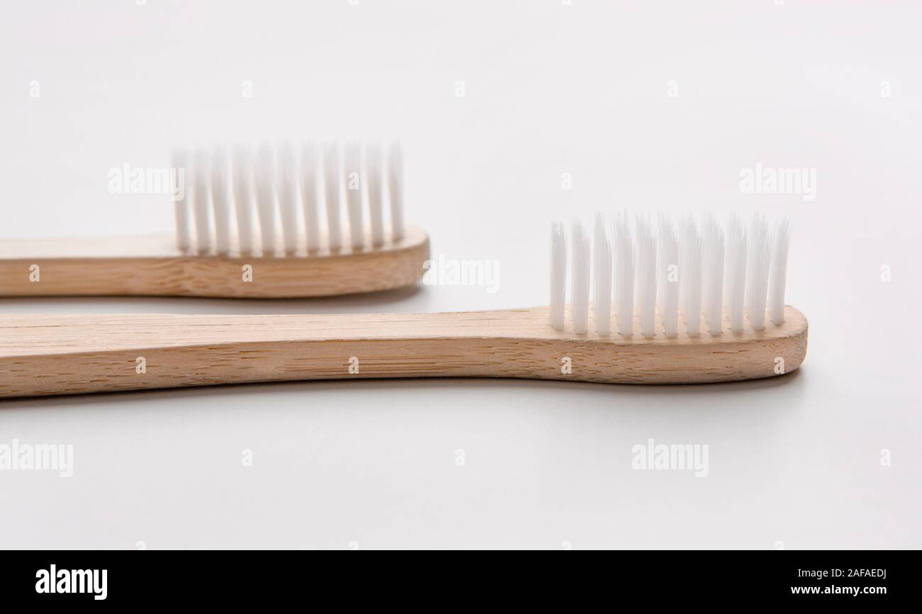 Two bamboo natural toothbrushes on white background Stock Photo - Alamy