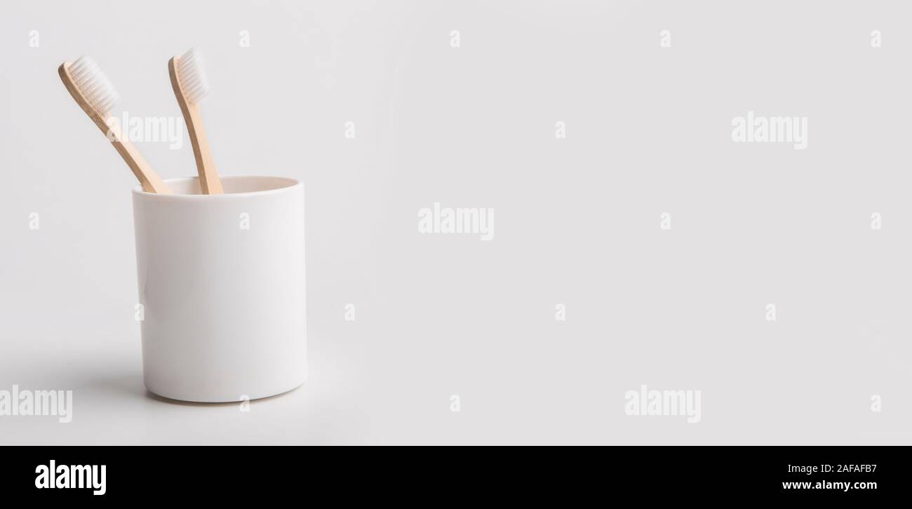 Holder with eco bamboo toothbrushes on white background Stock Photo - Alamy