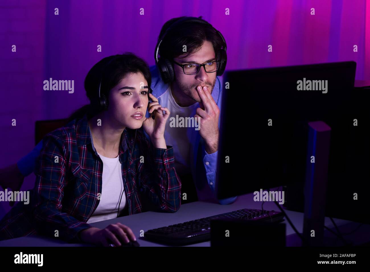 Favourite hobby. Gamers playing PC video game Stock Photo