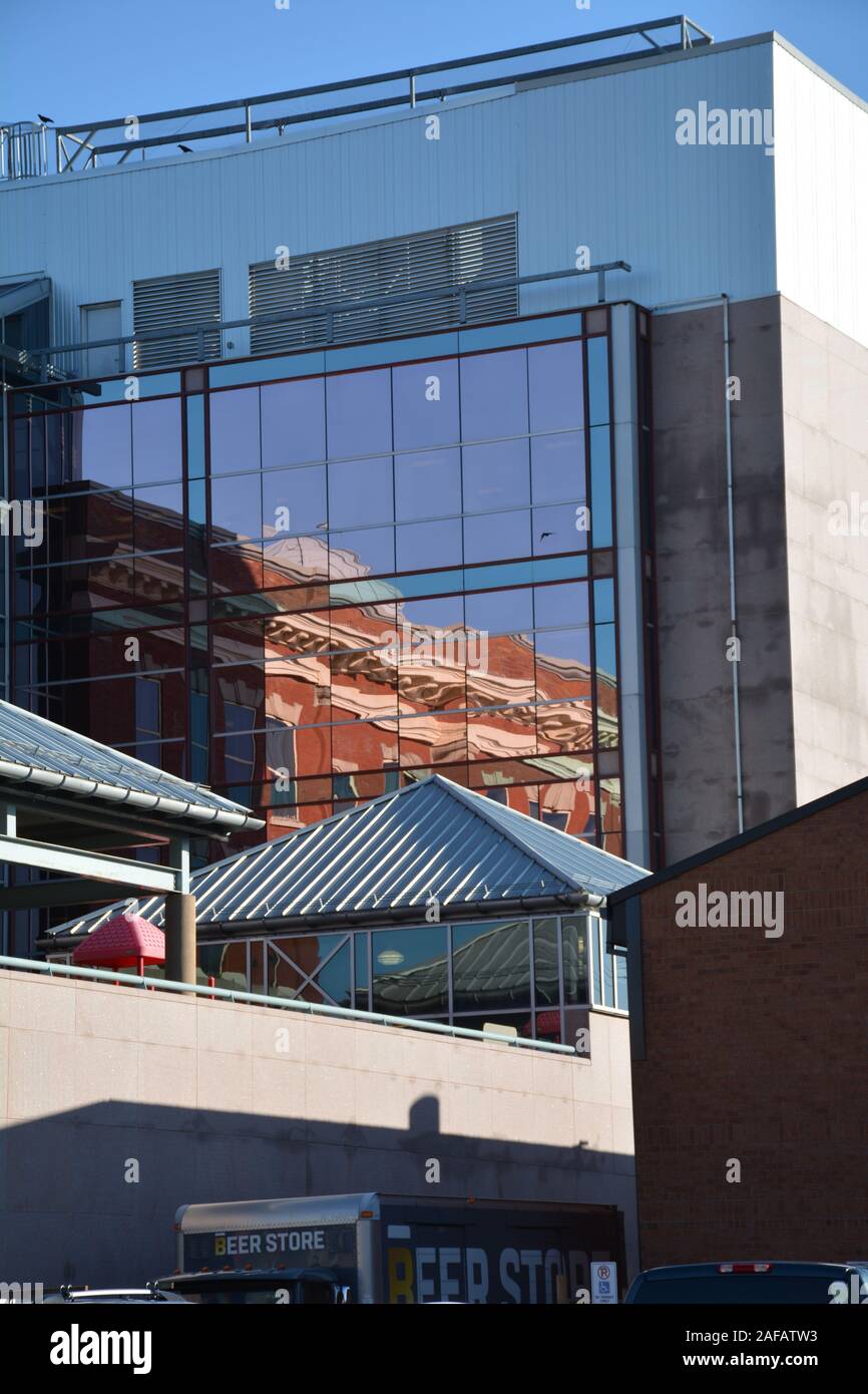 Office building reflected in glass building Stock Photo