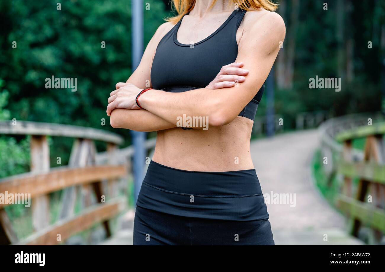Athlete woman posing with arms crossed Stock Photo - Alamy
