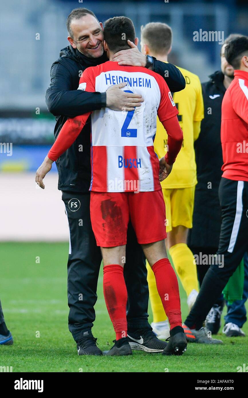 Heidenheim, Germany. 14th Dec, 2019. Soccer: 2nd Bundesliga, 17th matchday, 1st FC Heidenheim - Arminia Bielefeld, Voith-Arena. Coach Frank Schmidt (l) of 1. FC Heidenheim hugs Marnon Busch (r) of 1. FC Heidenheim after the match. Credit: Tom Weller/dpa - IMPORTANT NOTE: In accordance with the requirements of the DFL Deutsche Fußball Liga or the DFB Deutscher Fußball-Bund, it is prohibited to use or have used photographs taken in the stadium and/or the match in the form of sequence images and/or video-like photo sequences./dpa/Alamy Live News Stock Photo