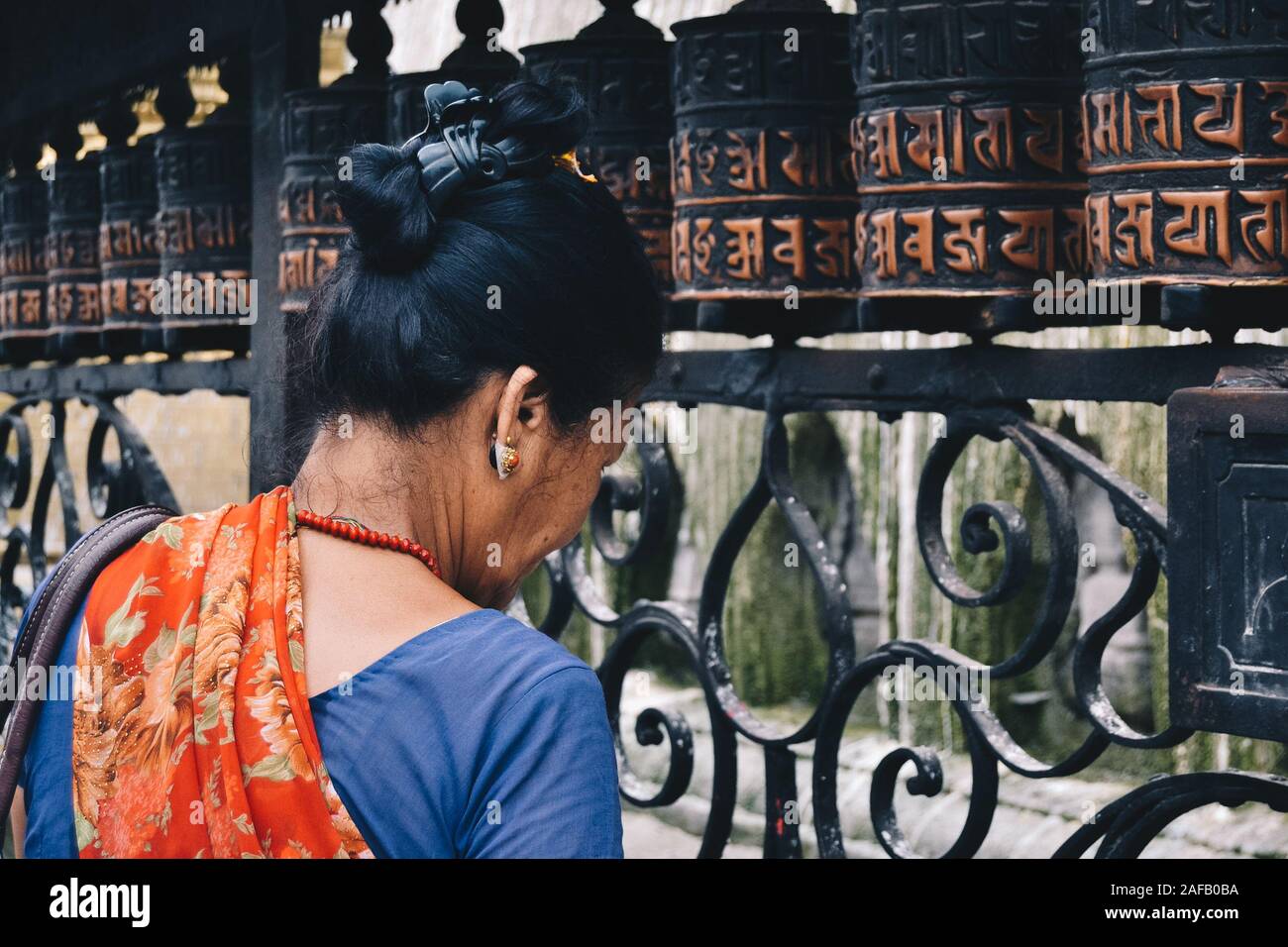 Woman praying the Monkey Temple in Nepal Stock Photo