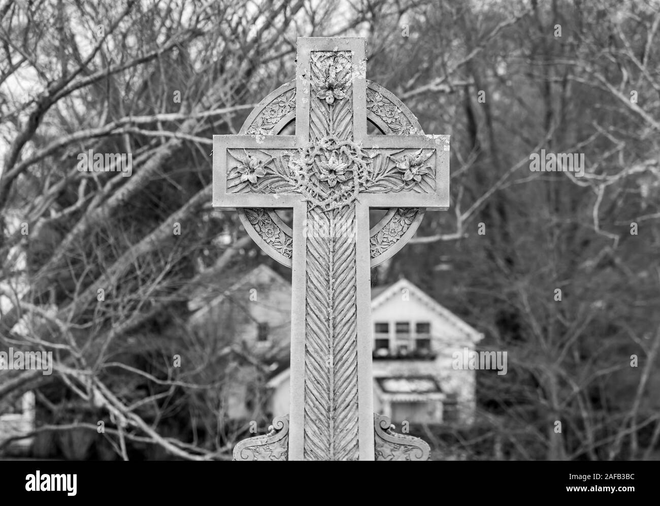 large ornate stone cross in a cemetery Stock Photo