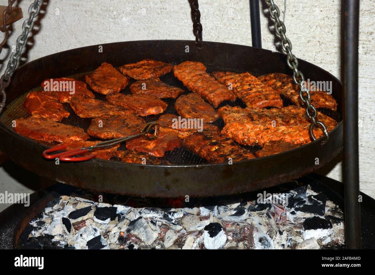 steak barbeque in big pan outdoor, closeup of big steaks outdoors on bonfire flame Stock Photo