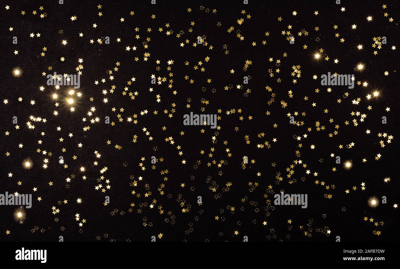 gold stars on dark black background. Festive holiday background ...