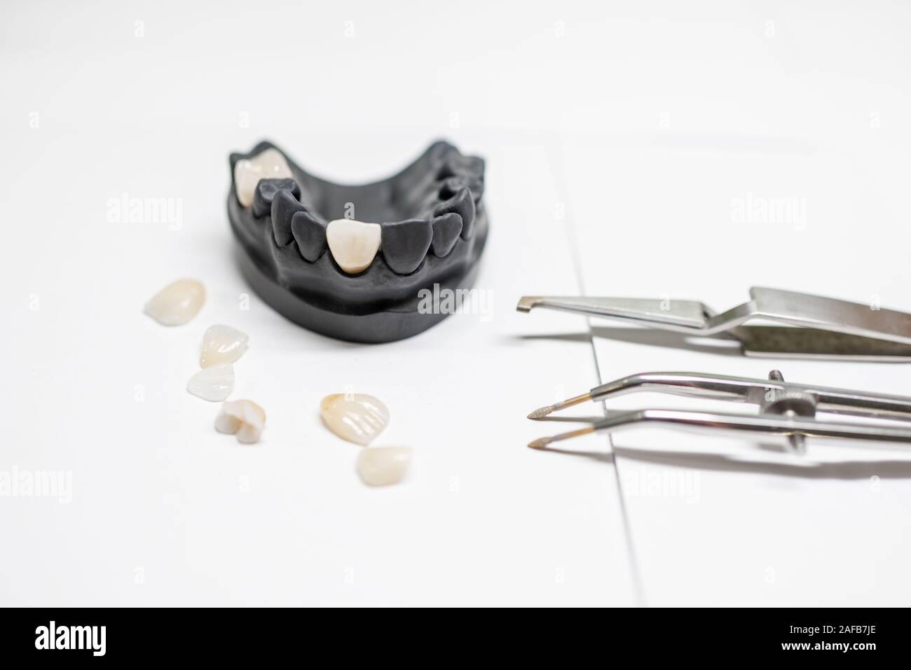 Artificial plaster jaw model with veneers and dental instruments on the ...
