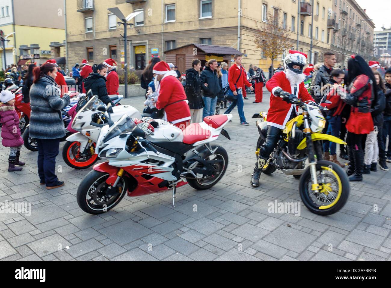 nyiregyhaza, hungaria - 07 DEC 2014: people dressed as santa claus on motorcycles. annual santa-themed charity fundraiser event on second sunday of ad Stock Photo