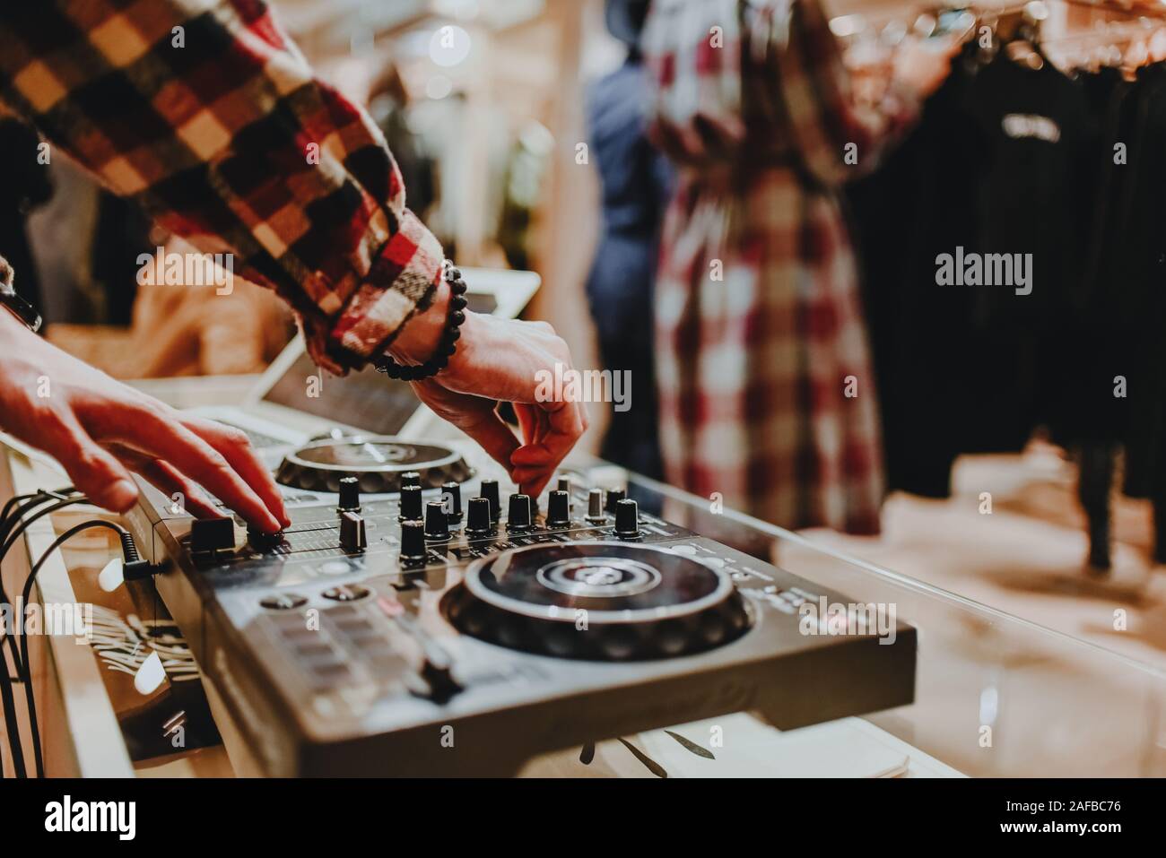 Dj mixes tracks at store opening event Stock Photo