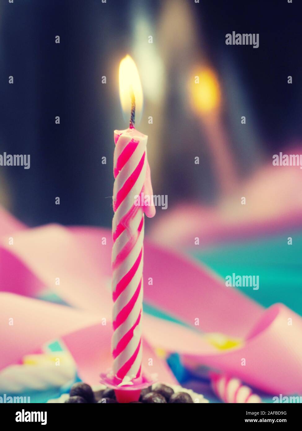 Burning Birthday Candle Cake On A color Background Stock Photo - Alamy