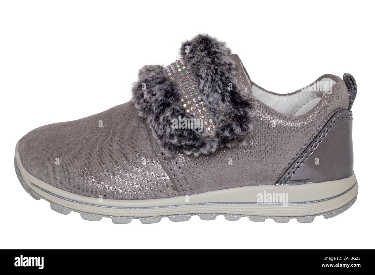 Child shoes fashion. Close-up of a single beautiful gray silver suede sneaker or sports shoe for girls with fur and rhinestone decoration isolated on Stock Photo