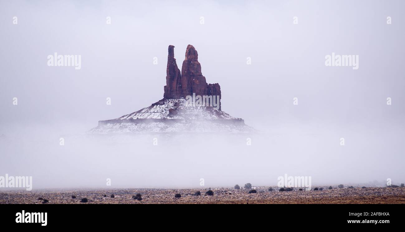 Fog and snow at the King on His Throne rock formation in Monument Valley Navajo Tribal Park Stock Photo