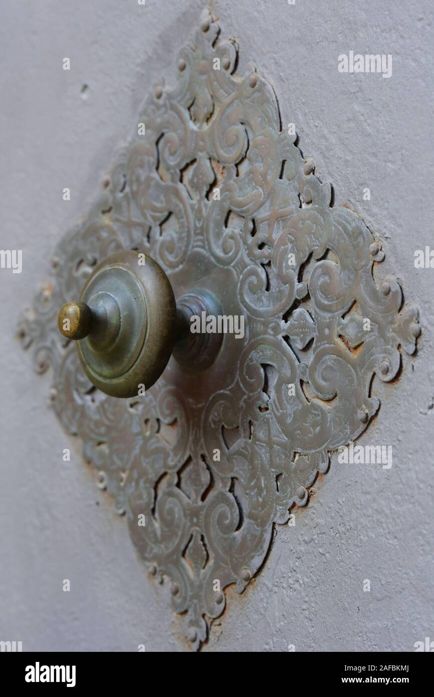 Ornate brass door handle close-up in the historic city of Palma, Majorca, Europe. Stock Photo