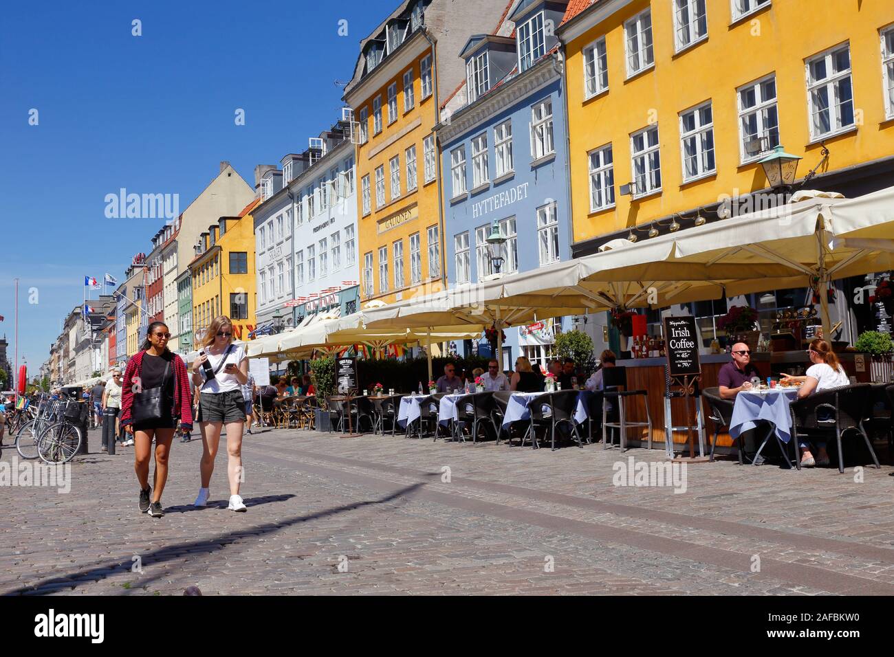 Copenhagen, Denmark - June 27, 2018: Street view of the Nyhavn pedestrians only street with its restaurants an colorful old buildings. Stock Photo