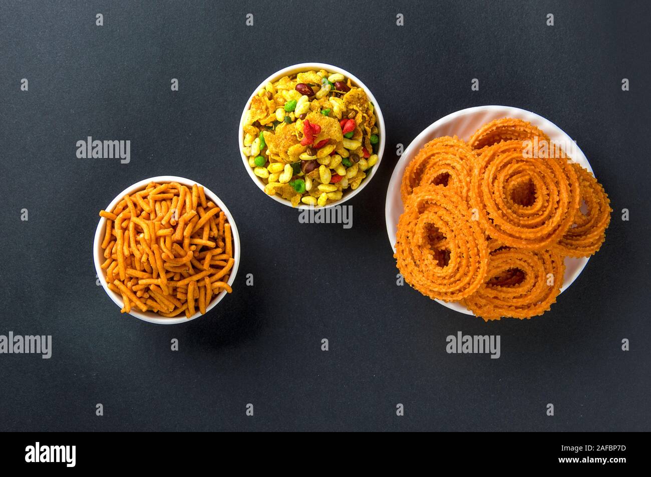 Indian Snack : Chakli, chakali or Murukku and Besan (Gram flour) Sev and chivada or chiwada. Diwali Food Stock Photo