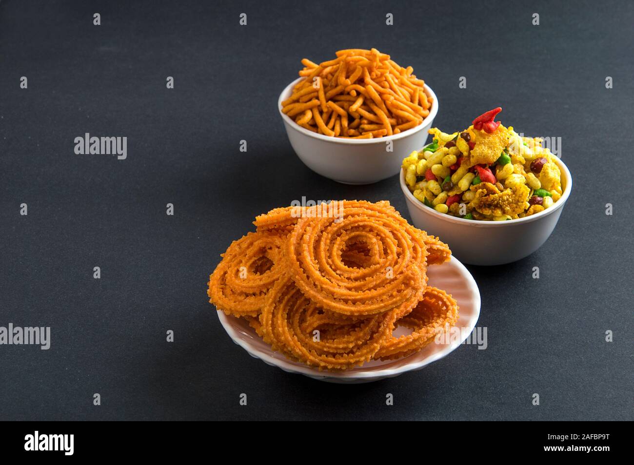 Indian Snack : Chakli, chakali or Murukku and Besan (Gram flour) Sev and chivada or chiwada. Diwali Food Stock Photo