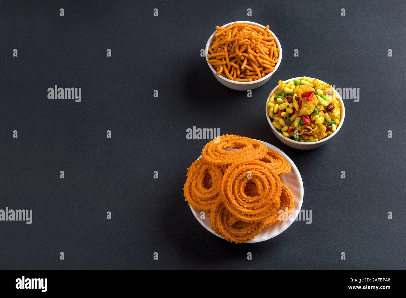 Indian Snack : Chakli, chakali or Murukku and Besan (Gram flour) Sev and chivada or chiwada. Diwali Food Stock Photo