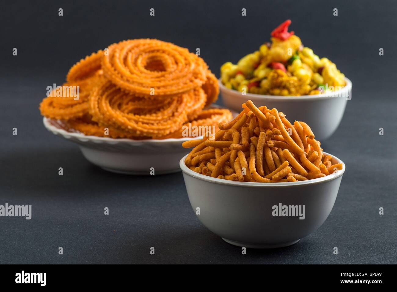 Indian Snack : Chakli, chakali or Murukku and Besan (Gram flour) Sev and chivada or chiwada. Diwali Food Stock Photo