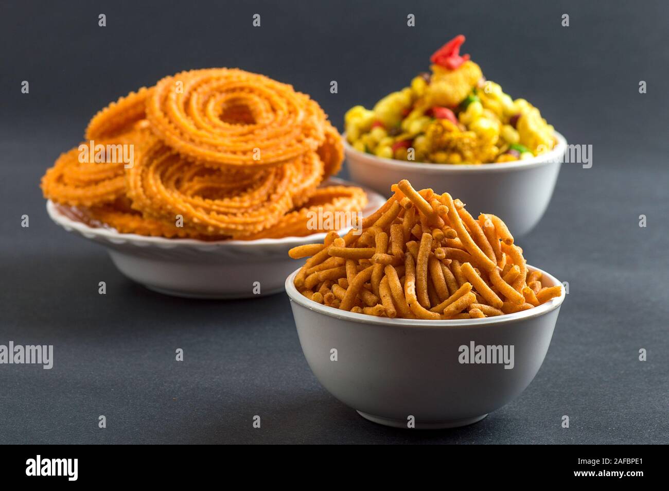 Indian Snack : Chakli, chakali or Murukku and Besan (Gram flour) Sev and chivada or chiwada. Diwali Food Stock Photo