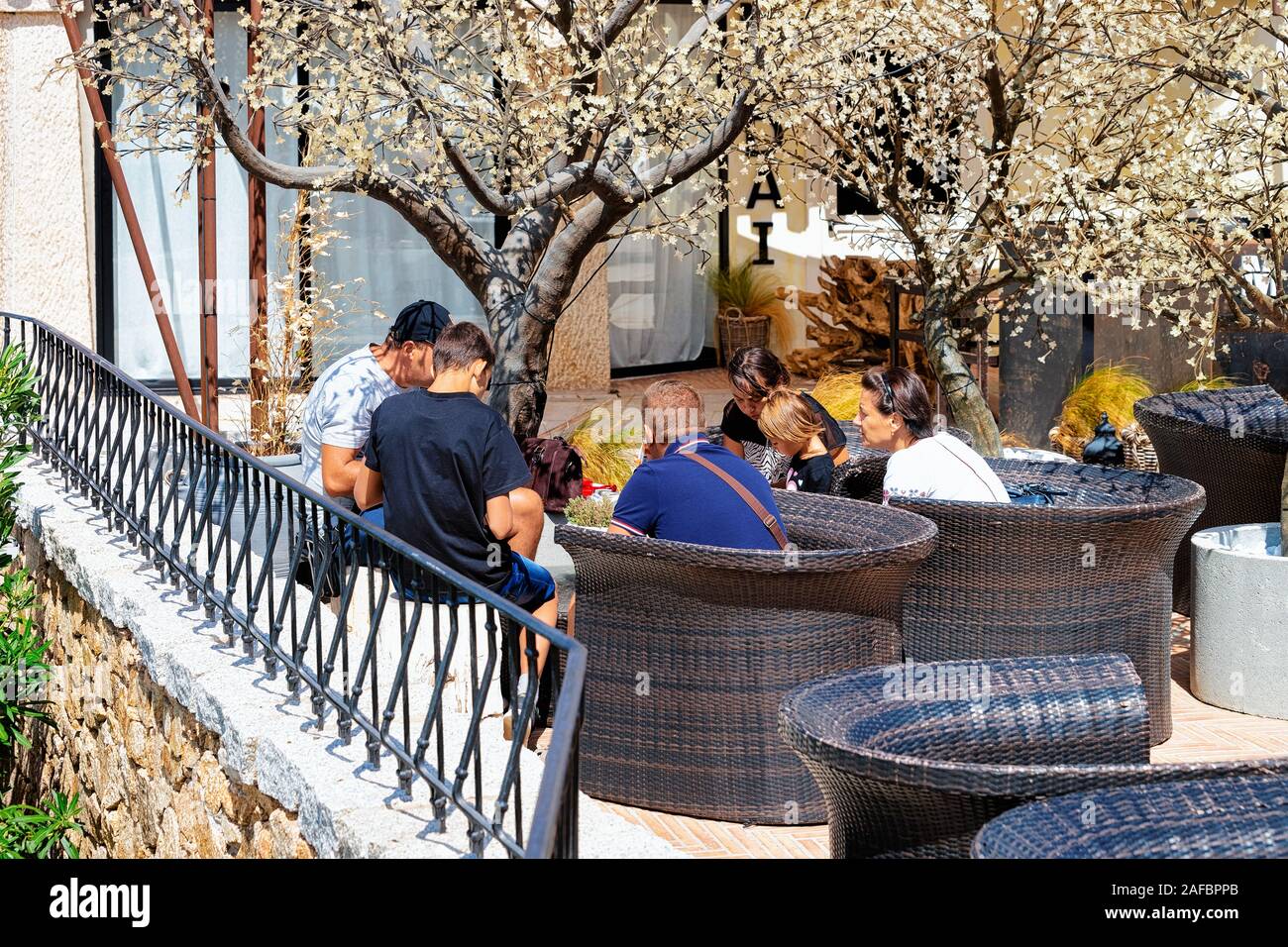 Street cafe with tables and chairs at Porto Cervo Stock Photo