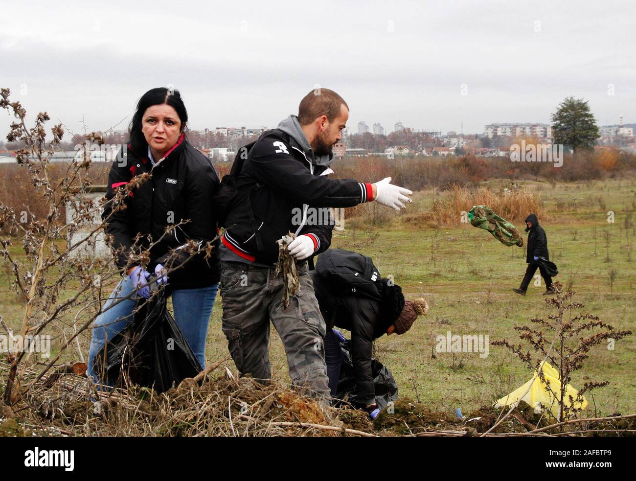 Skopje, North Macedonia. 14th Dec, 2019. People collect litters during a mass clean-up campaign about 2 kilometers north-west from the center of Skopje, North Macedonia, Dec. 14, 2019. Thousands of citizens joined the mass clean-up campaign organized by the government of North Macedonia on Saturday. Credit: Darko Duridanski/Xinhua/Alamy Live News Stock Photo